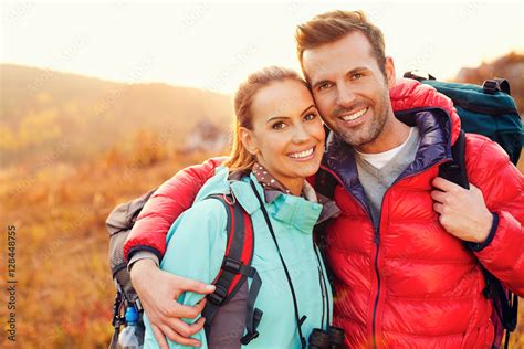 Portrait of beautiful couple hiking together during fall, autumn Stock ...