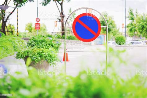 Outdoor No Parking Sign Beside Road With Blurred Background Stock Photo