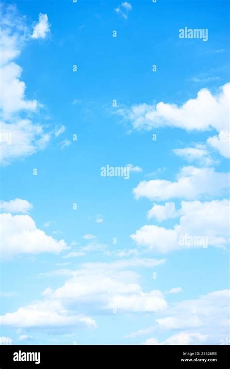 Blue sky white clouds - vertical background Stock Photo - Alamy