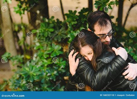 Affectionate Boyfriend Hugging His Girlfriend After She Receives Sad