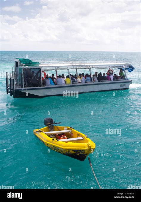 A glass bottom boat takes tourists on a reef tour at Green Island ...