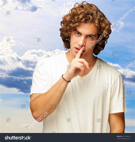 Portrait Of A Man With Finger On Lips Outdoor Stock Photo