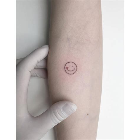 Smiley Face Tattoo Done On The Inner Forearm