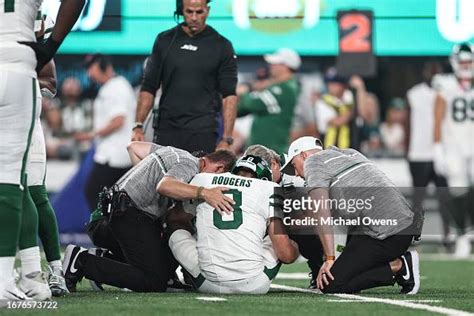 Aaron Rodgers Of The New York Jets Is Looked At By The Medical Staff