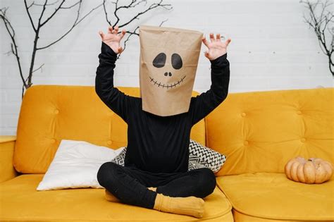 Premium Photo Spooky Kid Wearing A Paper Bag Over His Head A Scary