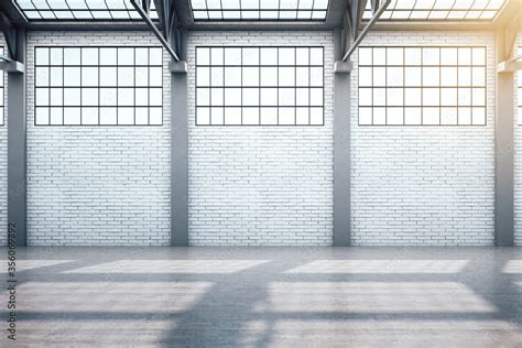 Modern warehouse interior with window and blank brick wall. Stock Photo ...