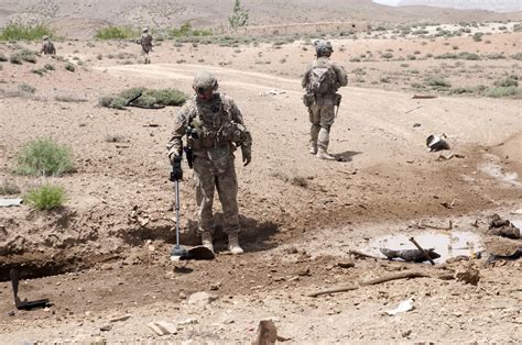 Counter Ied Teams Locate Roadside Bombs Using Metal Detectors On