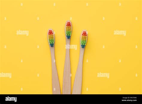 Photo Of Three Toothbrushes With Rainbow Colored Bristles Stock Photo