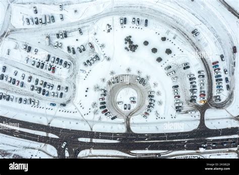 urban parking lot, covered with snow at winter season during snowfall ...