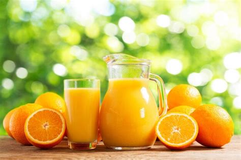 Premium Photo Glass Jar Of Fresh Orange Juice With Fresh Fruits