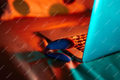 Premium Photo Toys For Sex On A Laptop On A Bright Neon Background