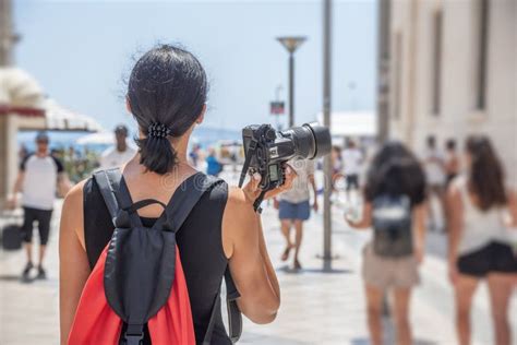 Tourist With A Camera Photographing The Streets And Points Of Interest