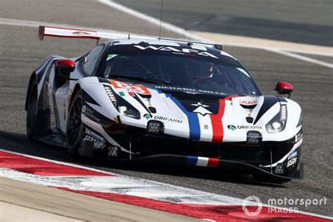 A Racing Car Driving On A Race Track