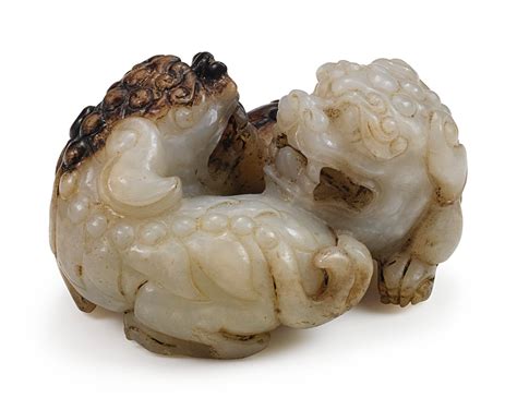 A Pale Celadon And Brown Jade Lion Group Qing Dynasty