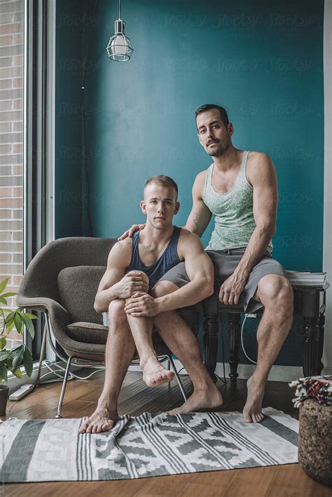 "Informal And Casual Portrait Of A Gay Male Couple At Home In Their