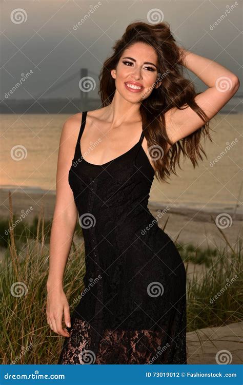 Glamorous Smiling Brunette Girl In Black Dress Posing On The Beach Stock Photo Image Of Beach