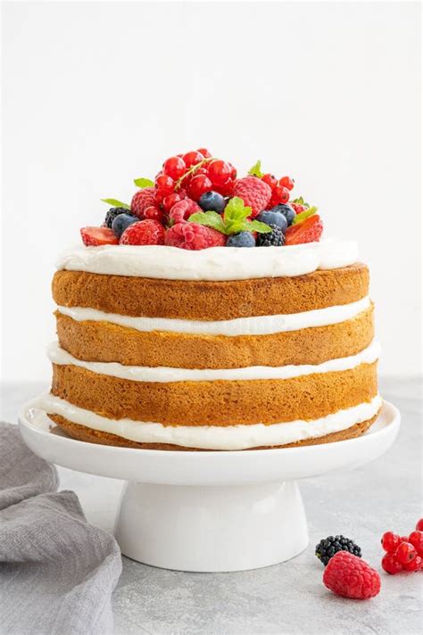 Homemade Naked Layered Vanilla Cake With Whipped Cream And Fresh Berries On Top On A Gray