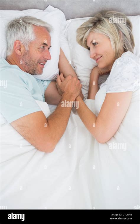 Loving Mature Man And Woman Lying In Bed Stock Photo Alamy