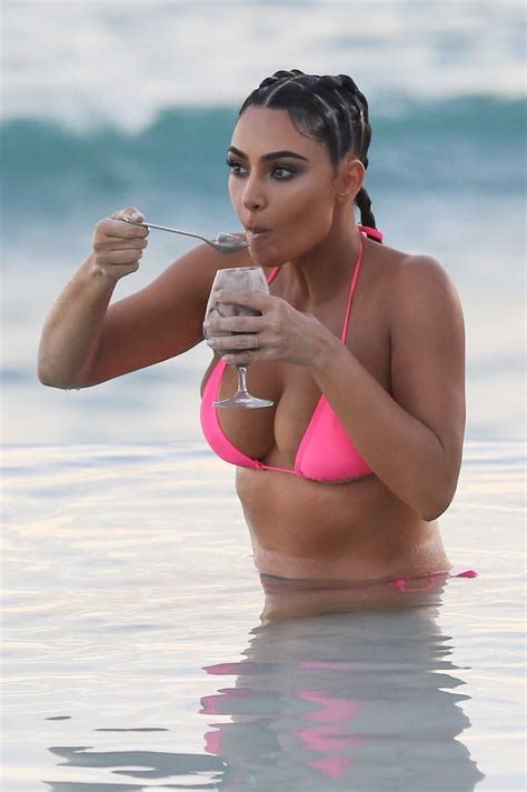 Kim Kardashian In A Pink Bikini Posing On The Beach For A KKW Beauty