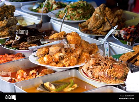 malaysian street food displayed   outdoor food stall   wide