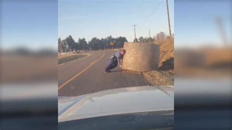 Trooper Clears Road Hazard Rolling Hay Bale Out Of Traffic Path