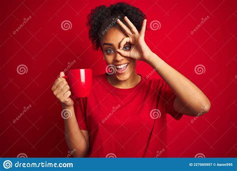 Young African American Woman Drinking A Cup Of Coffee Over Isolated Red