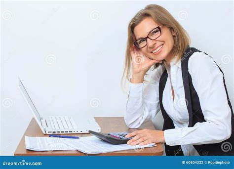 Happy Female Office Worker Sits At Her Desk And Stock Photo Image Of