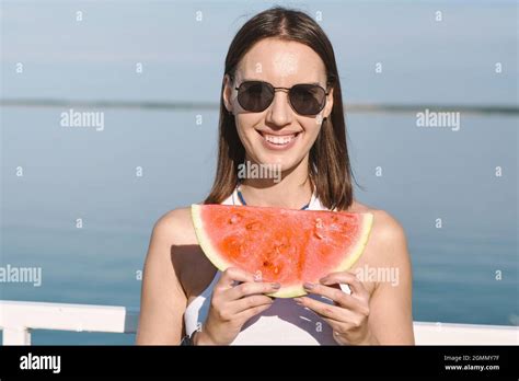 Happy Brunette Girl With Toothy Smile Holding Slice Of Sweet Juicy