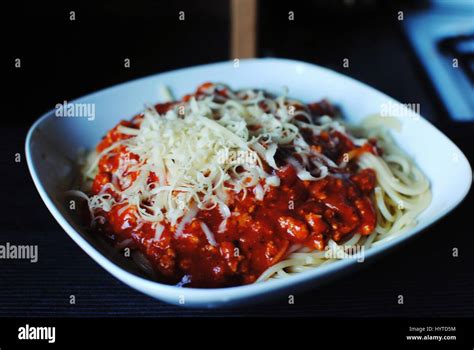 Delicious Spaghetti Bolognese With Olives And Mozzarella Cheese On Dark