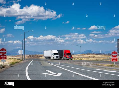 Industrial Long Hauler Carriers Two Big Rig Semi Trucks With High Cabs