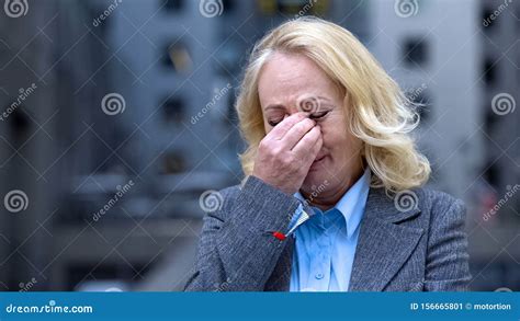 Desperate Aged Woman In Business Suit Crying Outdoors Office Building