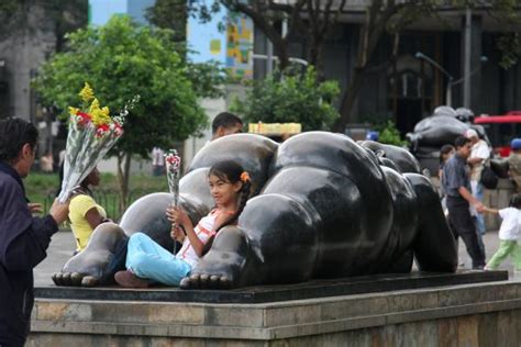 Naked woman on top of a head on Botero Square Plaza Botero Medellín