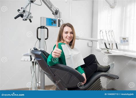 Beautiful Female Patient With Braces On Teeth Sitting In Dental Chair