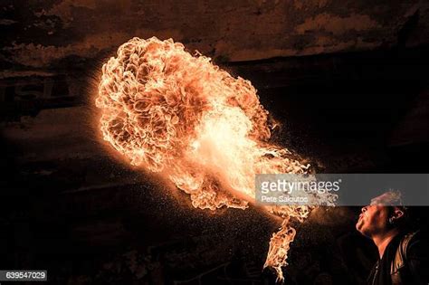 Man Blowing On Fire Photos And Premium High Res Pictures Getty Images