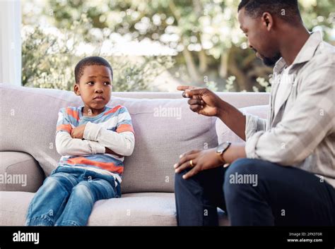 You cant behave like that. a little boy being scolded b his father at home Stock Photo - Alamy