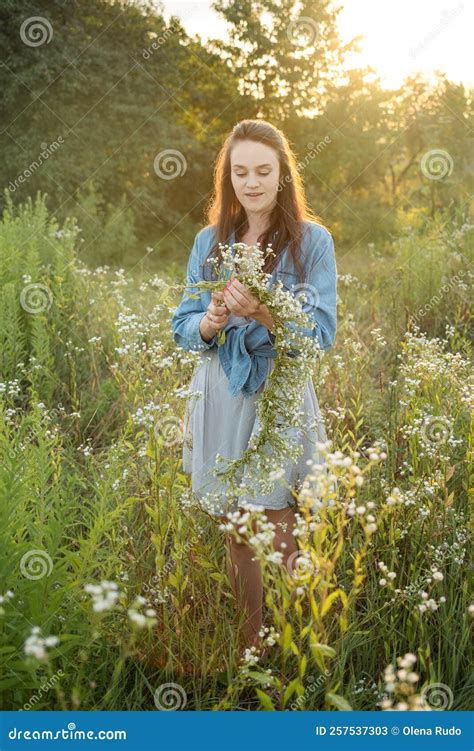 Beautiful Girl Walking On Field On Summer With Wildflowers Stock Image