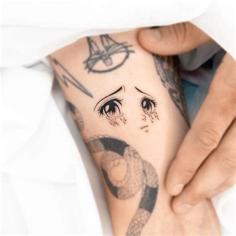 Cartoon Style Crying Eyes Tattoo Located On The Inner