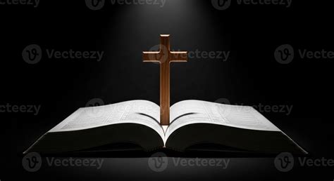 Open Holy Bible with Wooden Cross Spiritual Light Beam on Dark