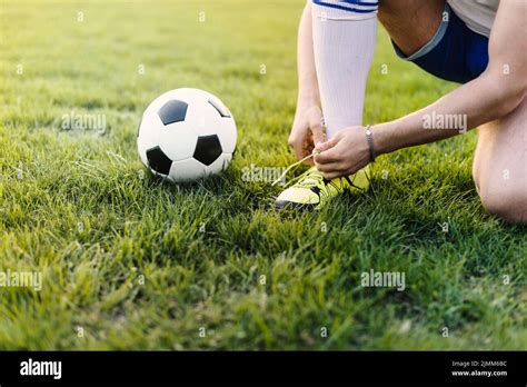 Crop Sportsman Tying Laces Field Stock Photo Alamy