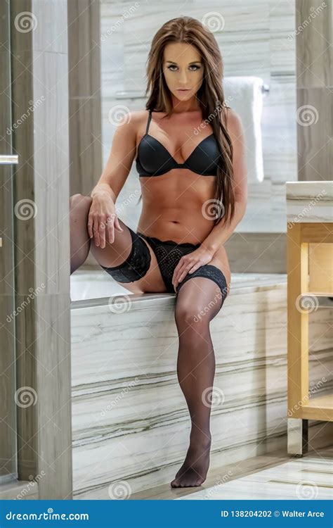 Gorgeous Brunette Model Relaxing At Home In Lingerie Stock Photo