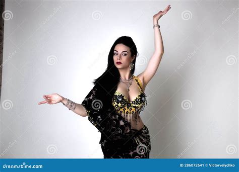 A Pretty Girl Brunette Who Dances Go Go And Belly Dance Stretching Posing In Studio In Black