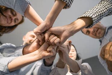 Top View Of Business People Putting Hands Together Multiracial