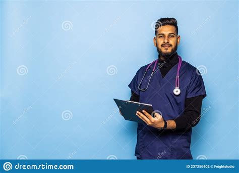 Indian Male Doctor Holding A Blank Clipboard And Looking At Him