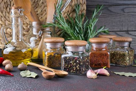 Kitchen Utensils Herbs Colorful Dry Spices In Glass Jars Stock Photo