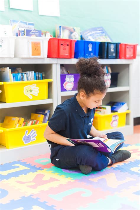 Molina Upper 18.19 girl reading on carpet - Mastery Charter School