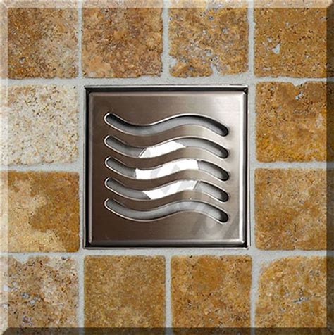 a stainless steel square drain cover with wavy lines on it's side in a ...