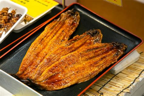 Premium Photo | Roasted skewered eel at a food market in the city of ...