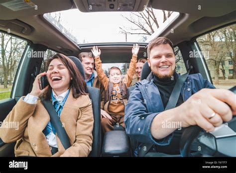 Car Travel Concept People In Car Rise Up Hands Road Trip Stock Photo