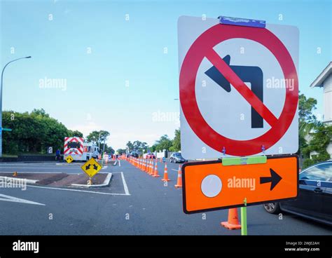 Detour Road Signs And Orange Traffic Cones On The Street Cars Driving