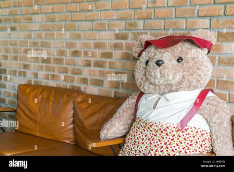 Cute teddy bear sitting on chair Stock Photo - Alamy